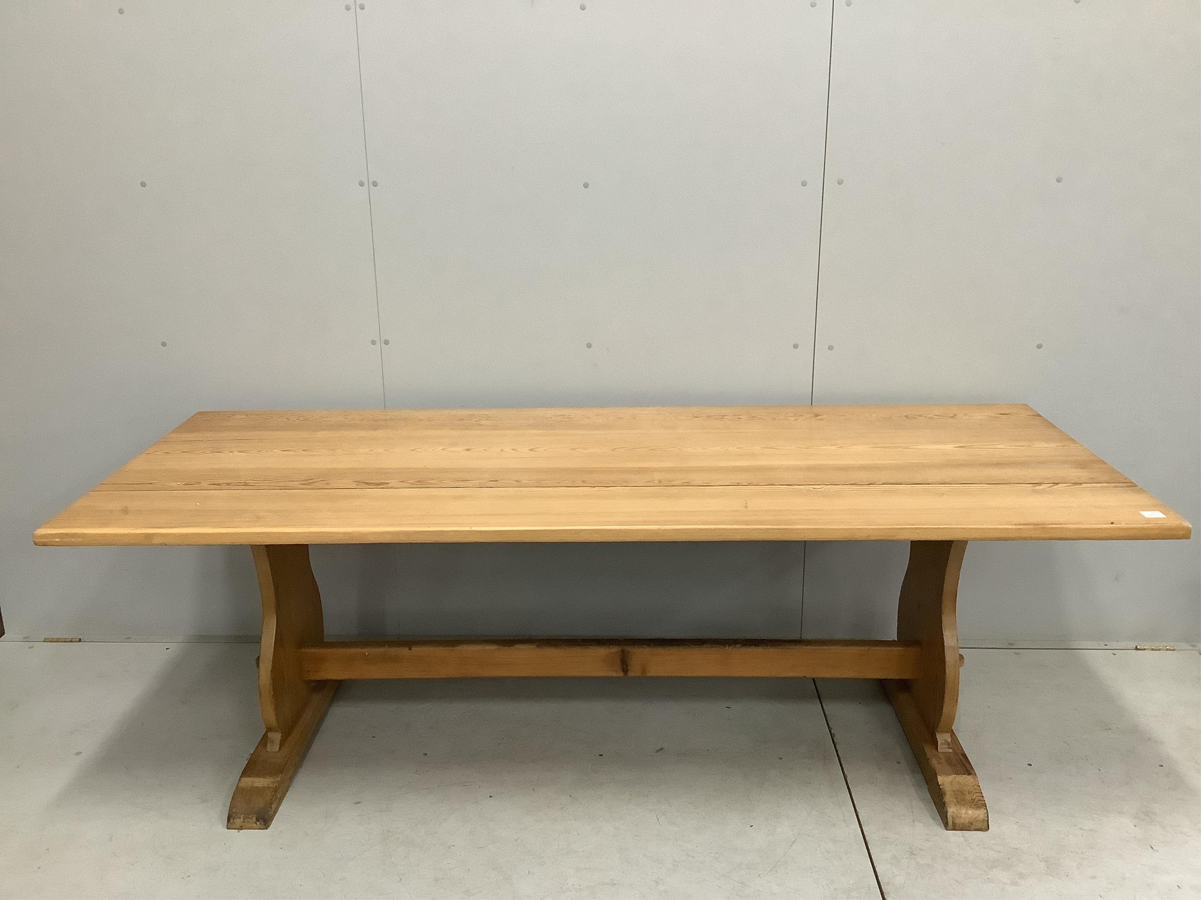 A modern rectangular pine refectory dining table, width 229cm, depth 90cm, height 73cm, together with a pine bench. Condition - fair